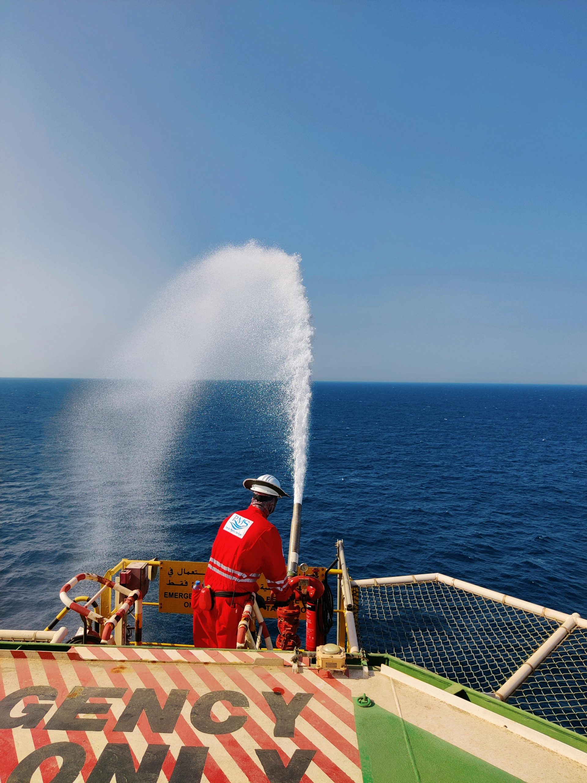 Man Working with Hose on Vessel